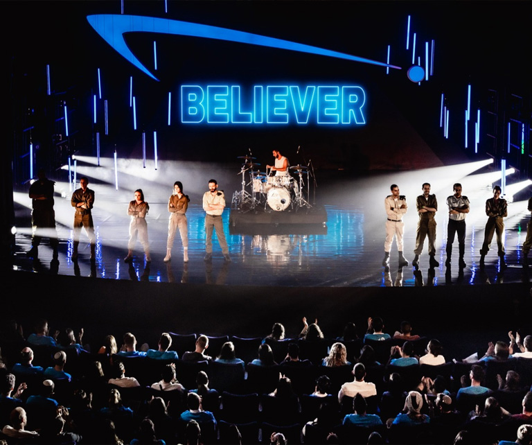 HESEG event performance with “Believer” stage visuals.