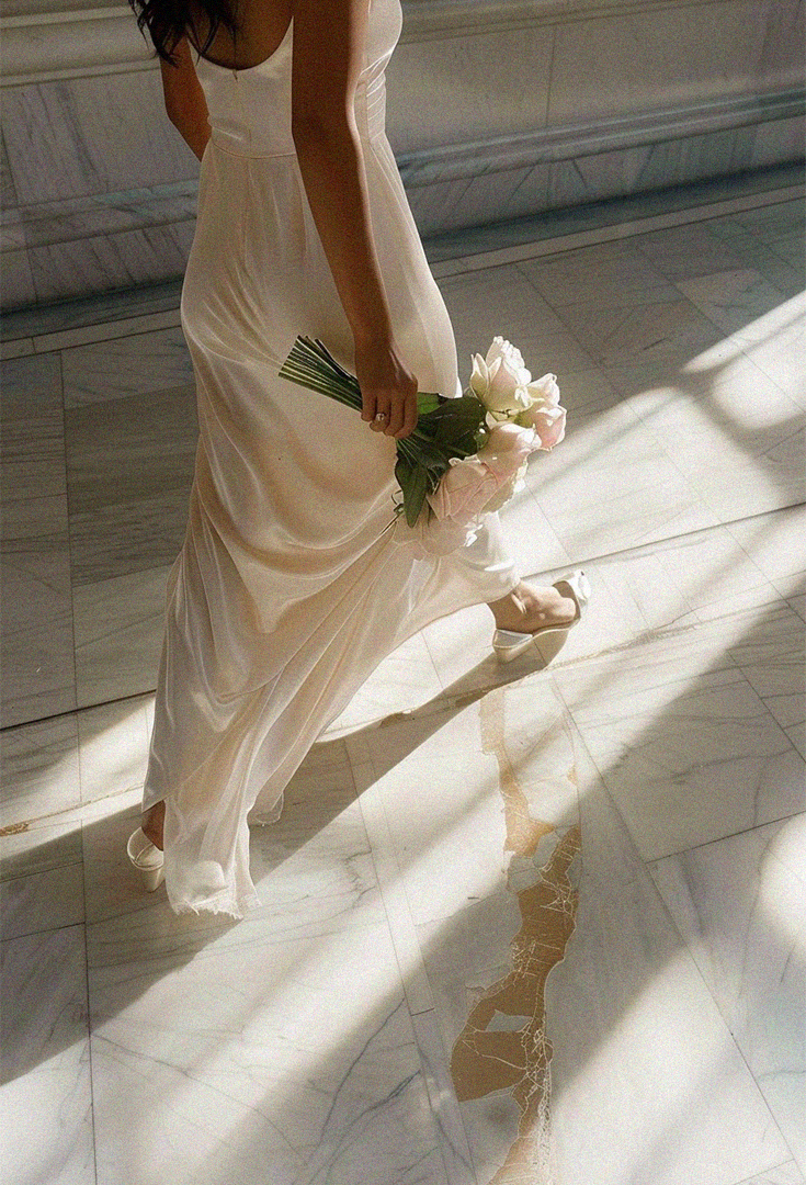a bride walking withy a bridal bouquet